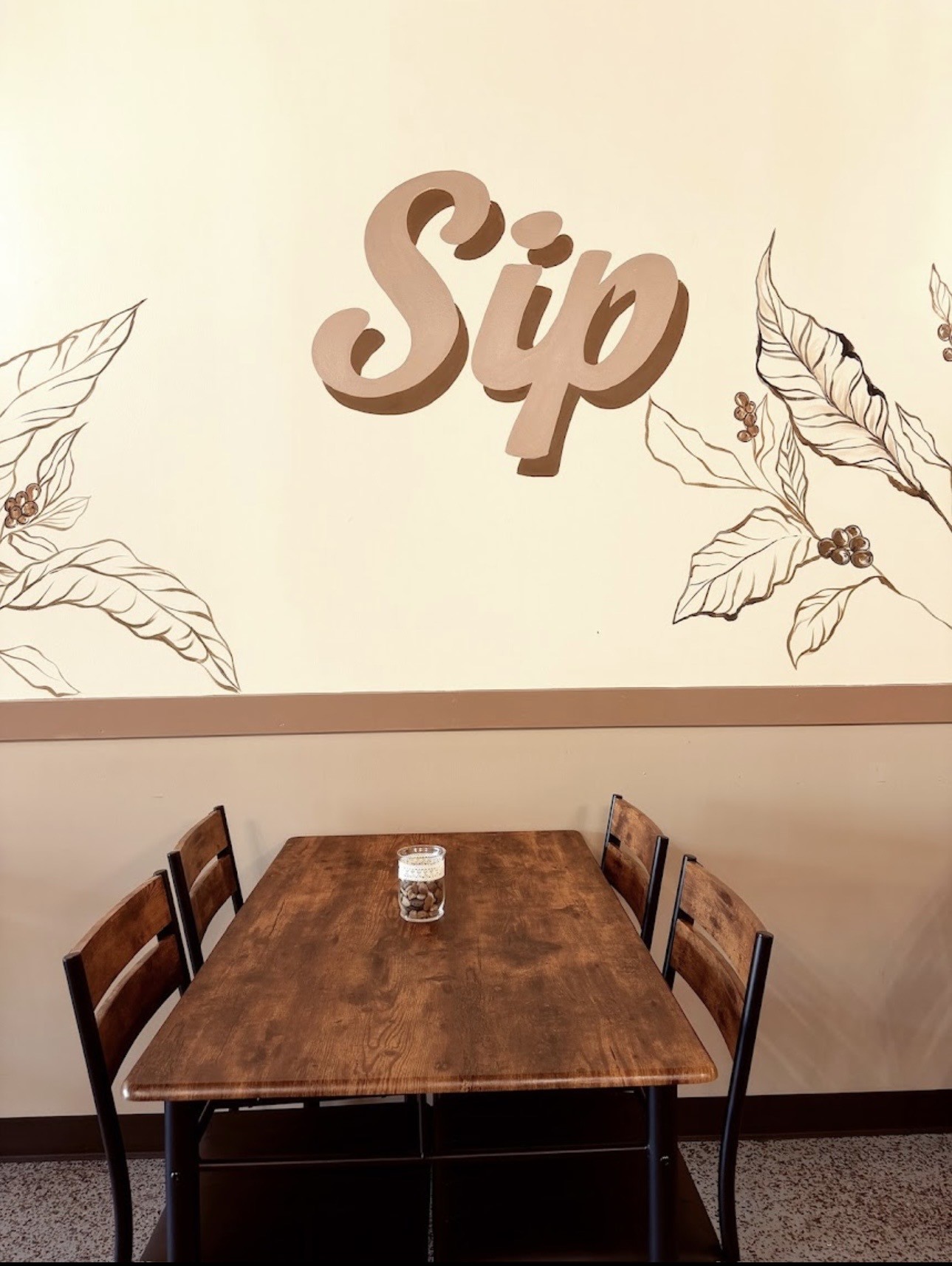 Coffee Hub seating beneath the café's Sip wall artwork